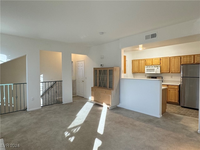 kitchen with light carpet and stainless steel refrigerator