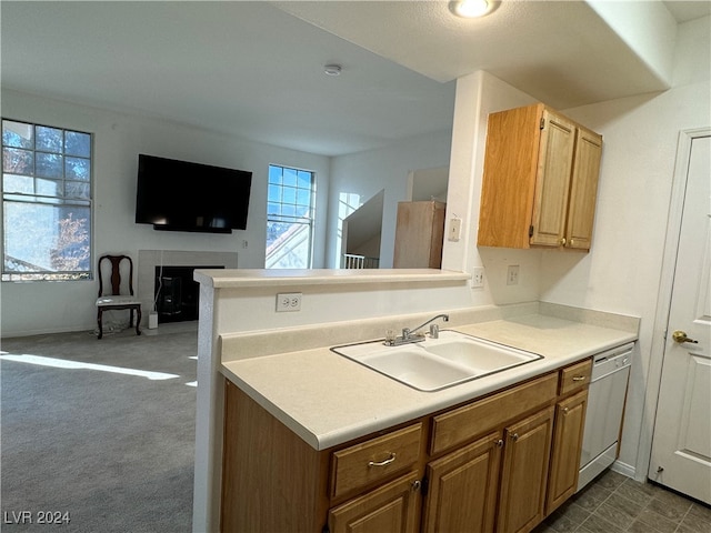 kitchen featuring dishwasher, dark colored carpet, kitchen peninsula, and sink