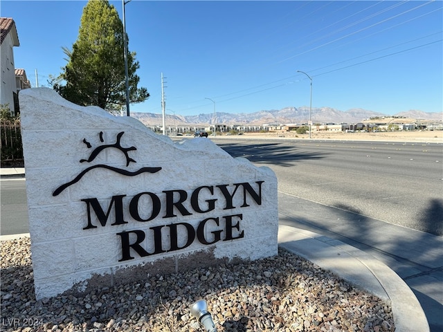 community sign with a mountain view