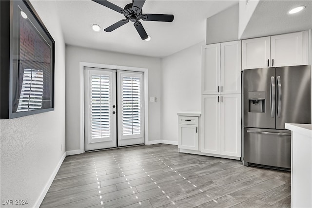 kitchen featuring stainless steel fridge with ice dispenser, light hardwood / wood-style flooring, white cabinets, and ceiling fan