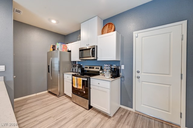 kitchen featuring light wood-type flooring, white cabinetry, and appliances with stainless steel finishes