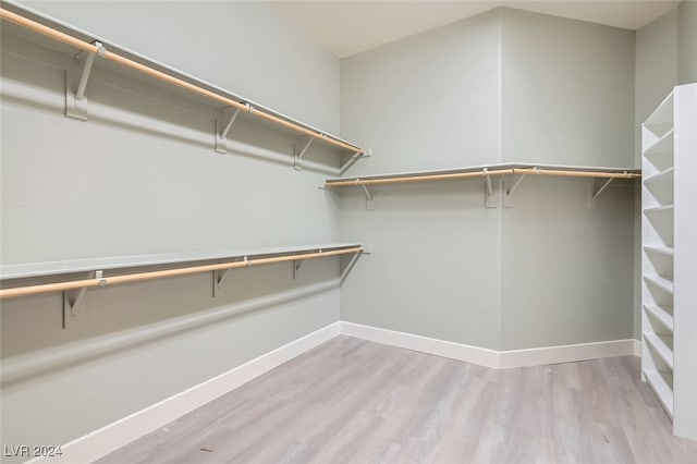 spacious closet featuring light hardwood / wood-style floors