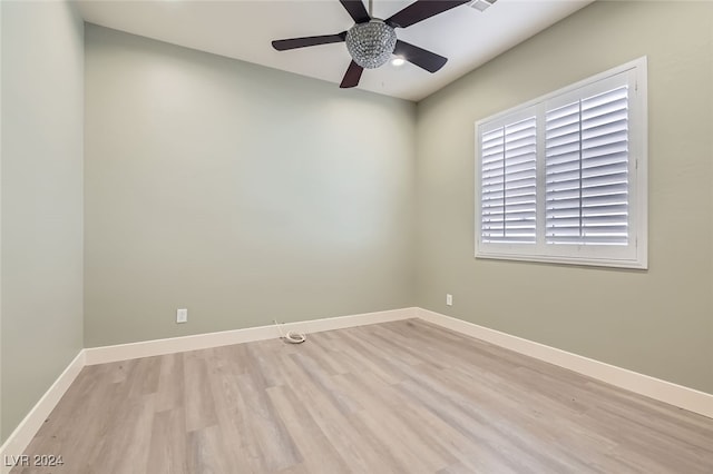 empty room with ceiling fan and light hardwood / wood-style floors