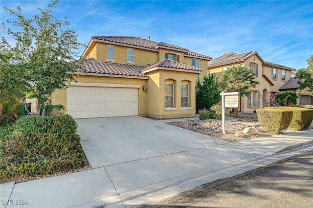 mediterranean / spanish-style home with a garage