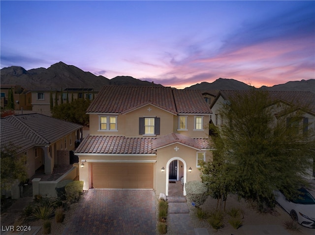 mediterranean / spanish-style home featuring a mountain view and a garage