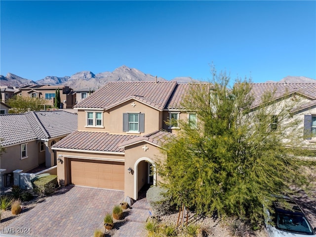 view of front of property featuring a mountain view and a garage