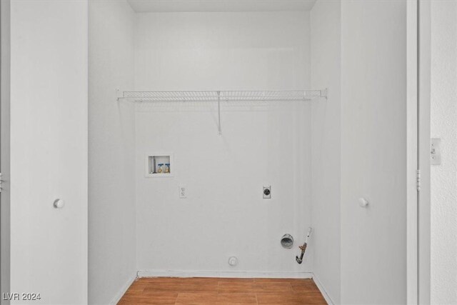 laundry area featuring hookup for a washing machine, hookup for an electric dryer, hookup for a gas dryer, laundry area, and wood finished floors