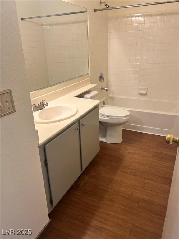 full bathroom with toilet, tub / shower combination, wood finished floors, and vanity