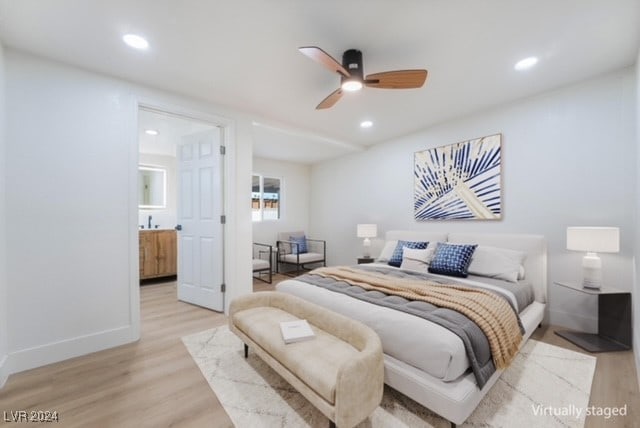 bedroom with light wood-type flooring, ensuite bath, and ceiling fan