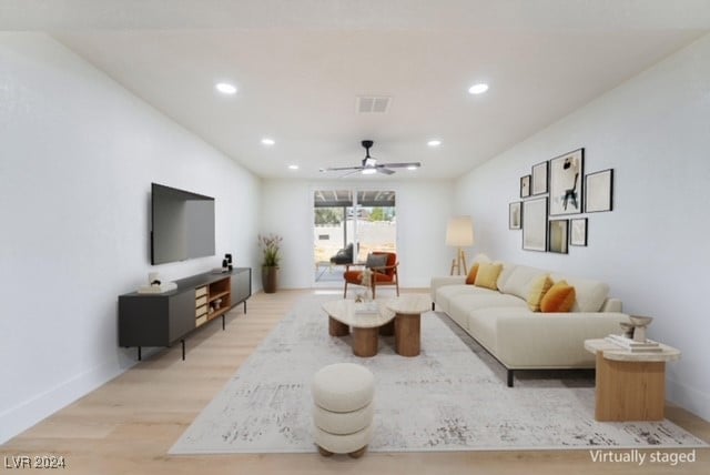 living room featuring light hardwood / wood-style floors and ceiling fan