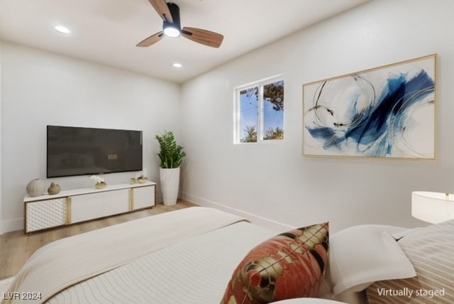 bedroom with ceiling fan and light wood-type flooring