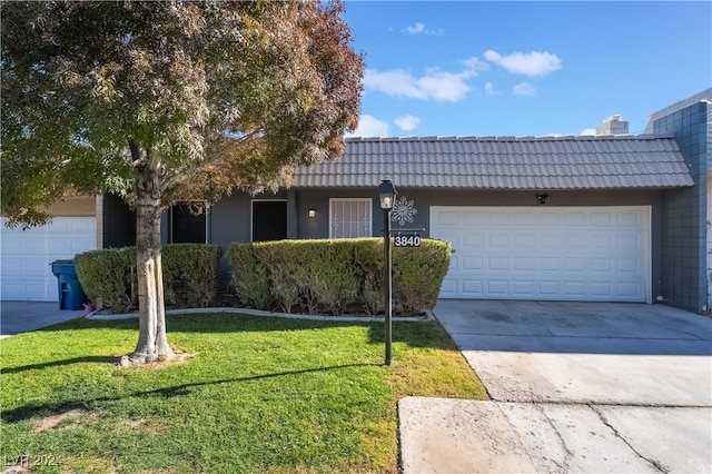 view of front of property featuring a garage and a front yard