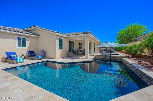 view of pool featuring an in ground hot tub and a patio