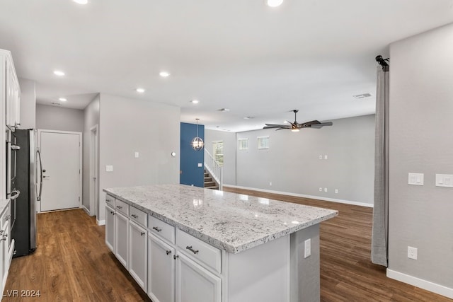 kitchen with a center island, dark hardwood / wood-style floors, white cabinetry, and ceiling fan