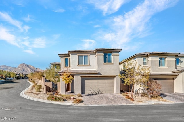 view of front of property with a mountain view and a garage