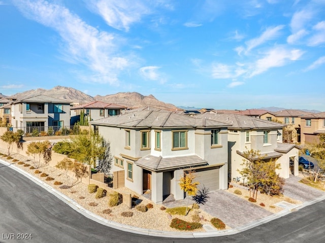 view of front of home with a mountain view and a garage