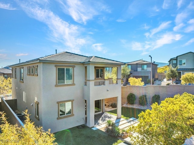 rear view of house featuring a balcony