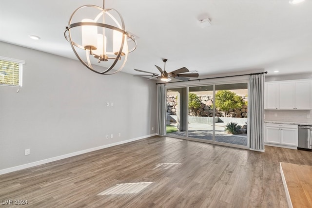 interior space featuring ceiling fan with notable chandelier and light hardwood / wood-style flooring