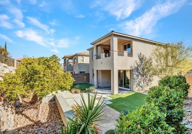 back of house with a patio area and a balcony