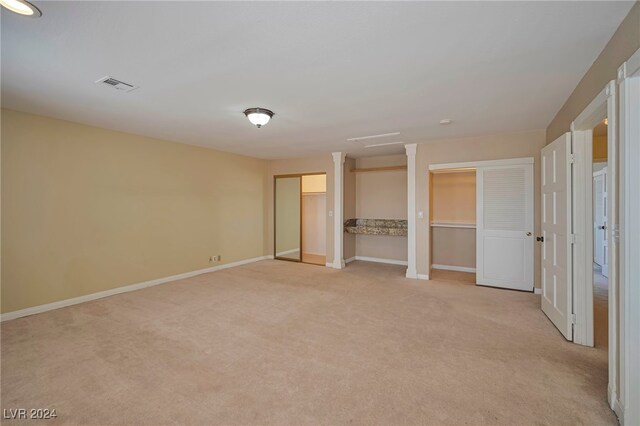 unfurnished bedroom featuring light colored carpet