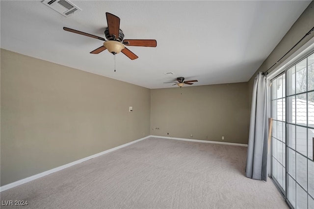 unfurnished room featuring light colored carpet and ceiling fan