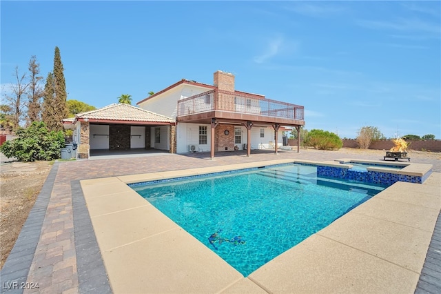 view of pool with a patio area and an in ground hot tub