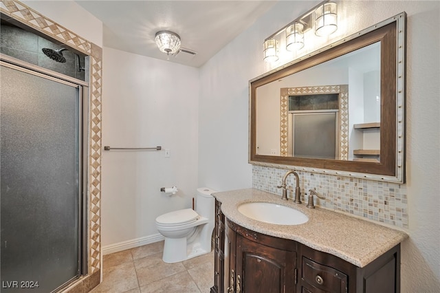 bathroom with walk in shower, backsplash, tile patterned floors, toilet, and vanity