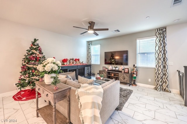 living room with ceiling fan and a wealth of natural light