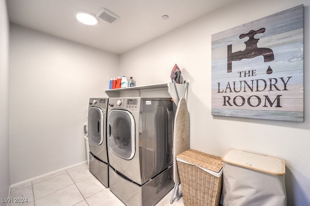 laundry area featuring washer and dryer and light tile patterned flooring