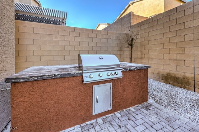 view of patio featuring an outdoor kitchen and area for grilling