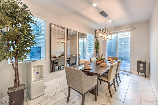 dining space with an inviting chandelier