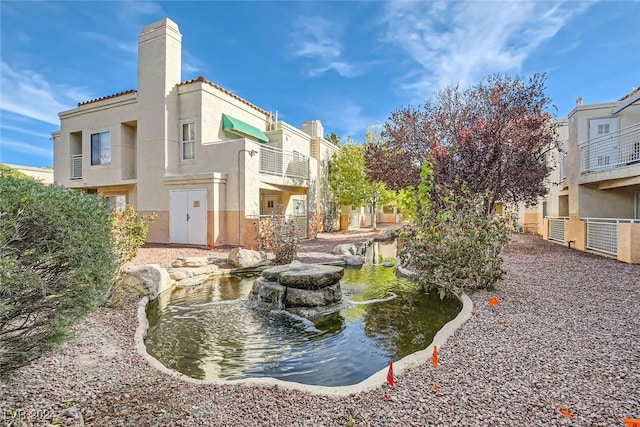 view of home's community with a small pond