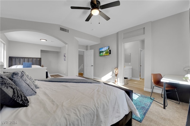 carpeted bedroom featuring ensuite bathroom and ceiling fan