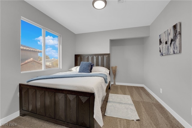 bedroom featuring light colored carpet