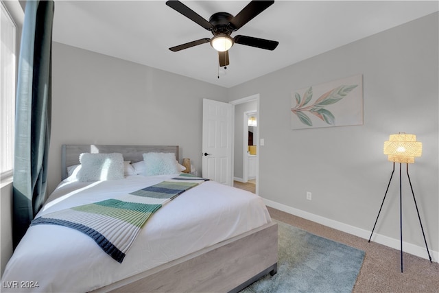 bedroom with light carpet, multiple windows, and ceiling fan