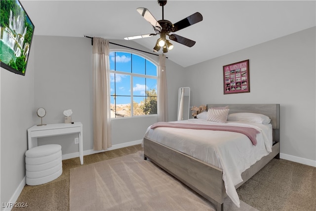 bedroom featuring light carpet, vaulted ceiling, and ceiling fan