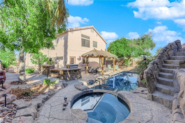 view of pool with an in ground hot tub, a gazebo, and a patio area