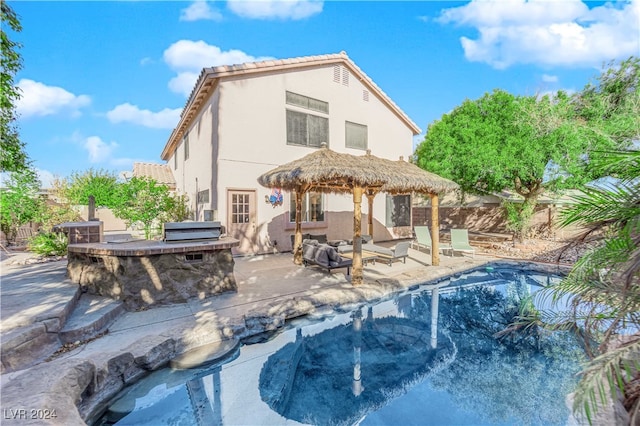 back of property featuring a patio and exterior kitchen