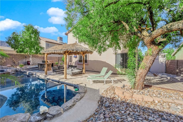 back of house with a gazebo, an outdoor hangout area, and a patio