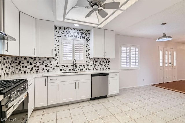 kitchen with pendant lighting, white cabinetry, sink, stainless steel dishwasher, and gas stove