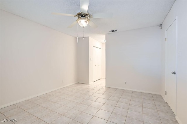 spare room with ceiling fan and a textured ceiling