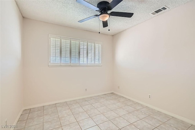 spare room with a textured ceiling and ceiling fan