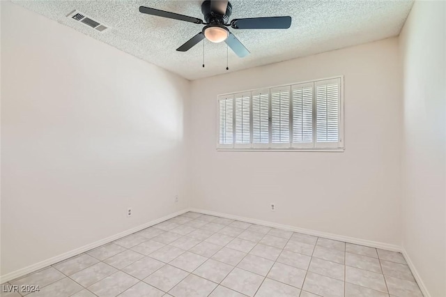 unfurnished room with ceiling fan and a textured ceiling