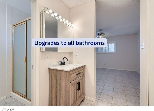 bathroom with vanity, tile patterned flooring, a shower with door, and ceiling fan