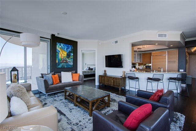 living room with dark hardwood / wood-style floors and ornamental molding