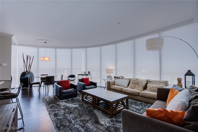 living room with floor to ceiling windows, plenty of natural light, dark hardwood / wood-style flooring, and ornamental molding