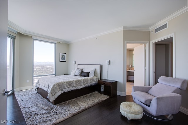 bedroom featuring connected bathroom, dark hardwood / wood-style floors, and crown molding