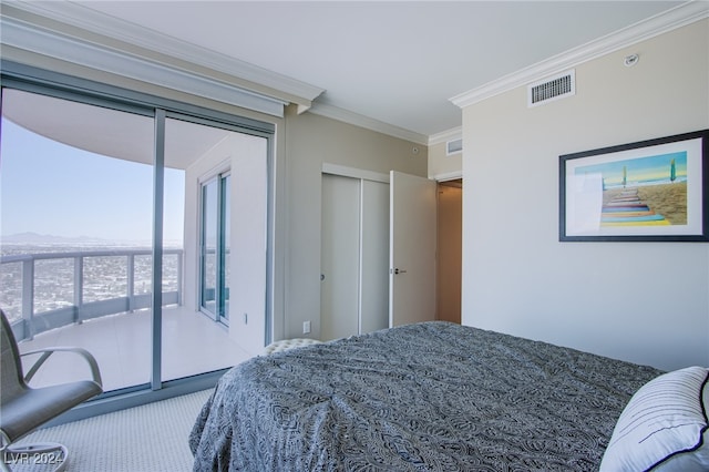 carpeted bedroom with crown molding, access to outside, and a closet