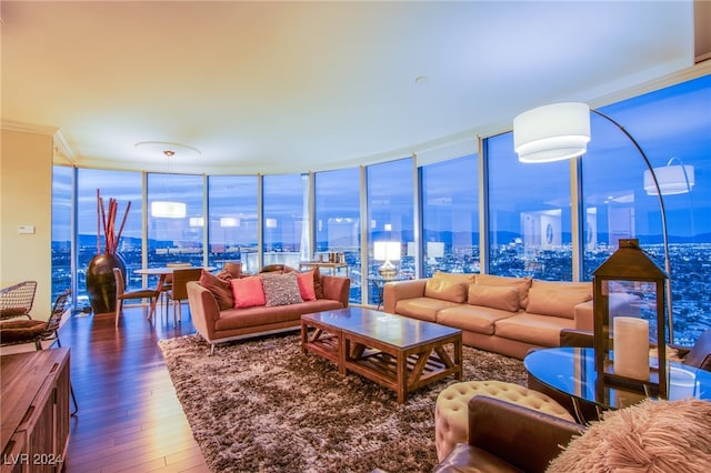 living room with hardwood / wood-style flooring, floor to ceiling windows, and ornamental molding