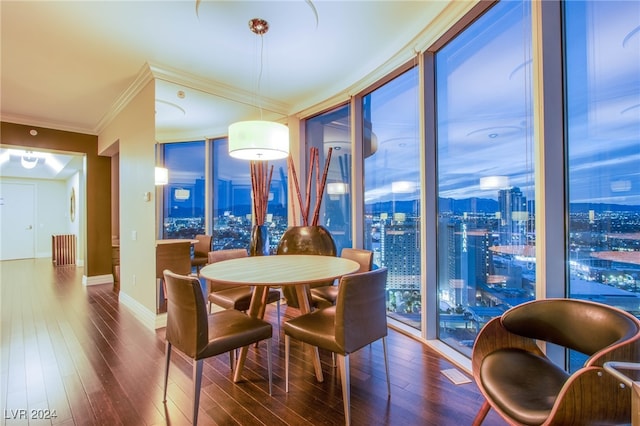 dining area with floor to ceiling windows, wood-type flooring, and crown molding